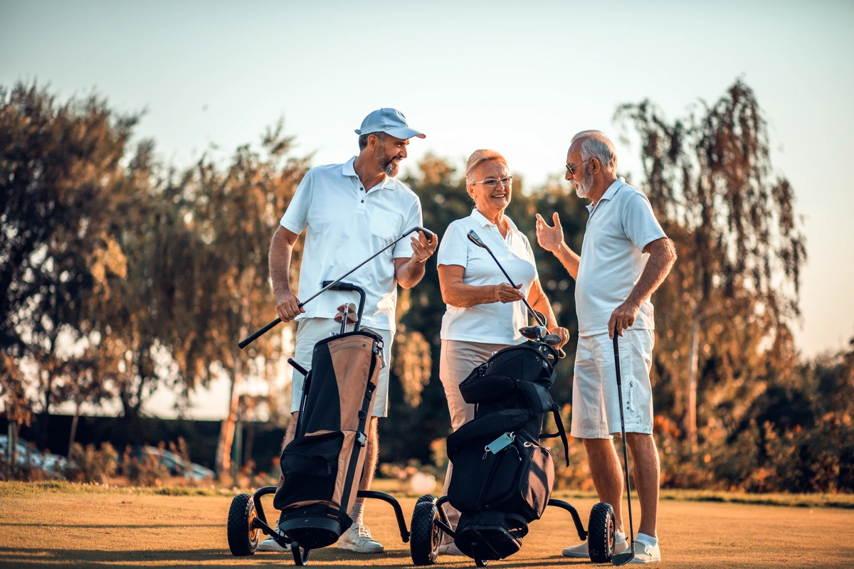 retired seniors in jacksonville golfing during golden hour