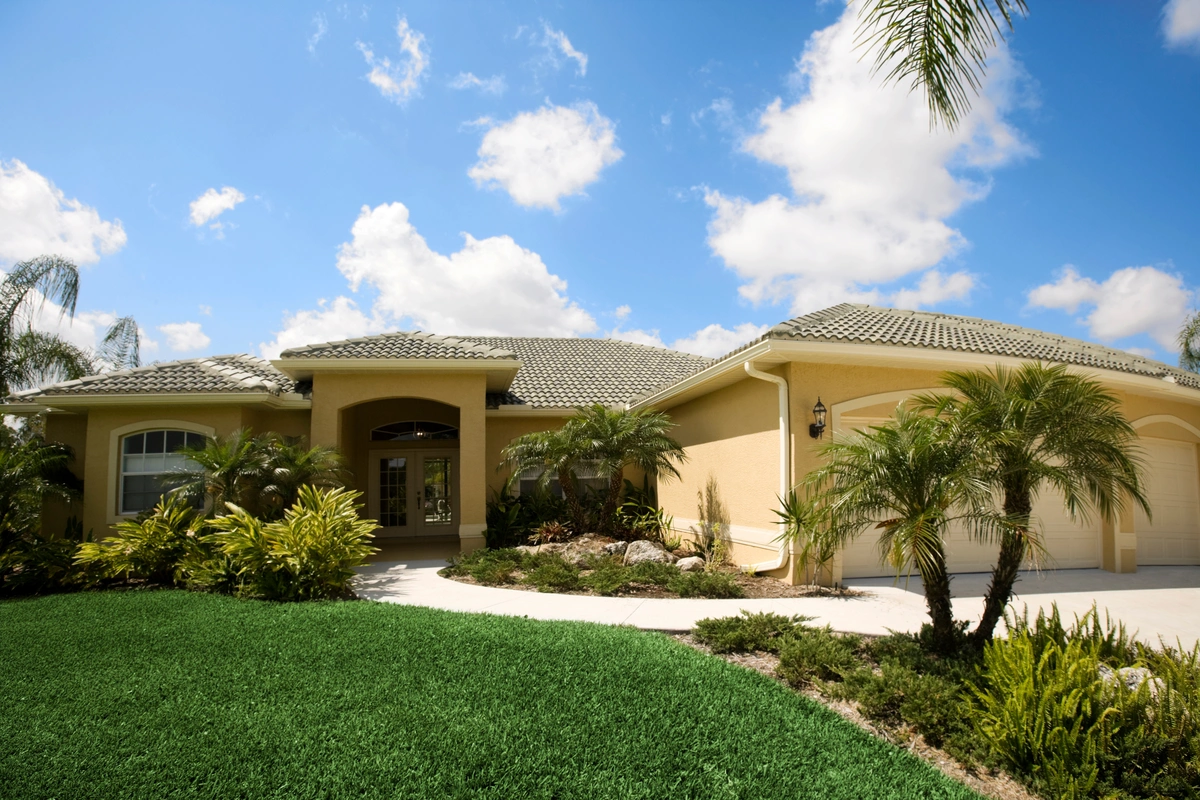 florida home with new tile roof against blue sky with clouds