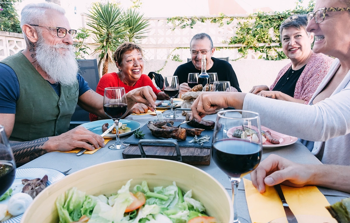 florida retired friend group eating outside of home on patio