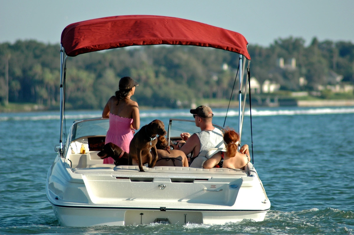 Florida homeowners out on a pontoon boat with red awning