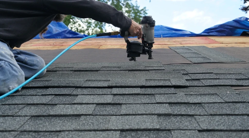 contractor using nail guns shows how to replace blown off shingles