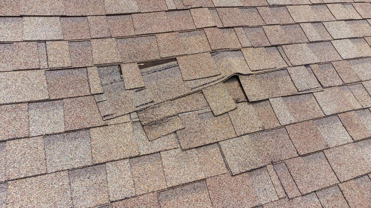 close up of minimal signs of storm damage with loose shingles