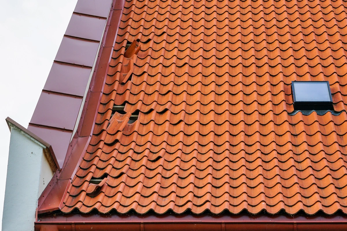 clay roof type with storm damage and fallen tiles