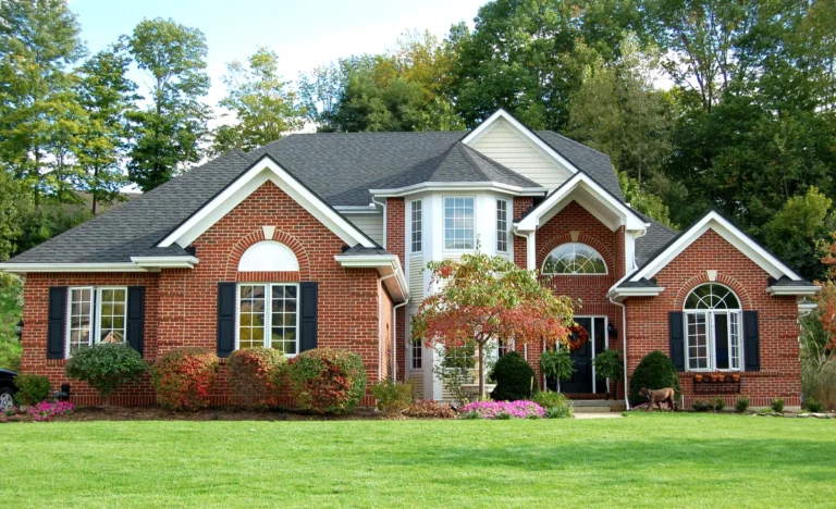 large family house with asphalt shingle roof and front yard