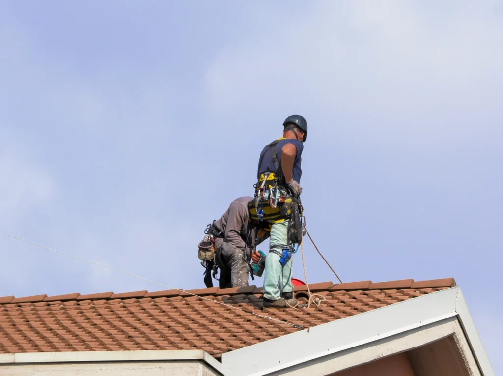 workers doing the house roof maintenance work
