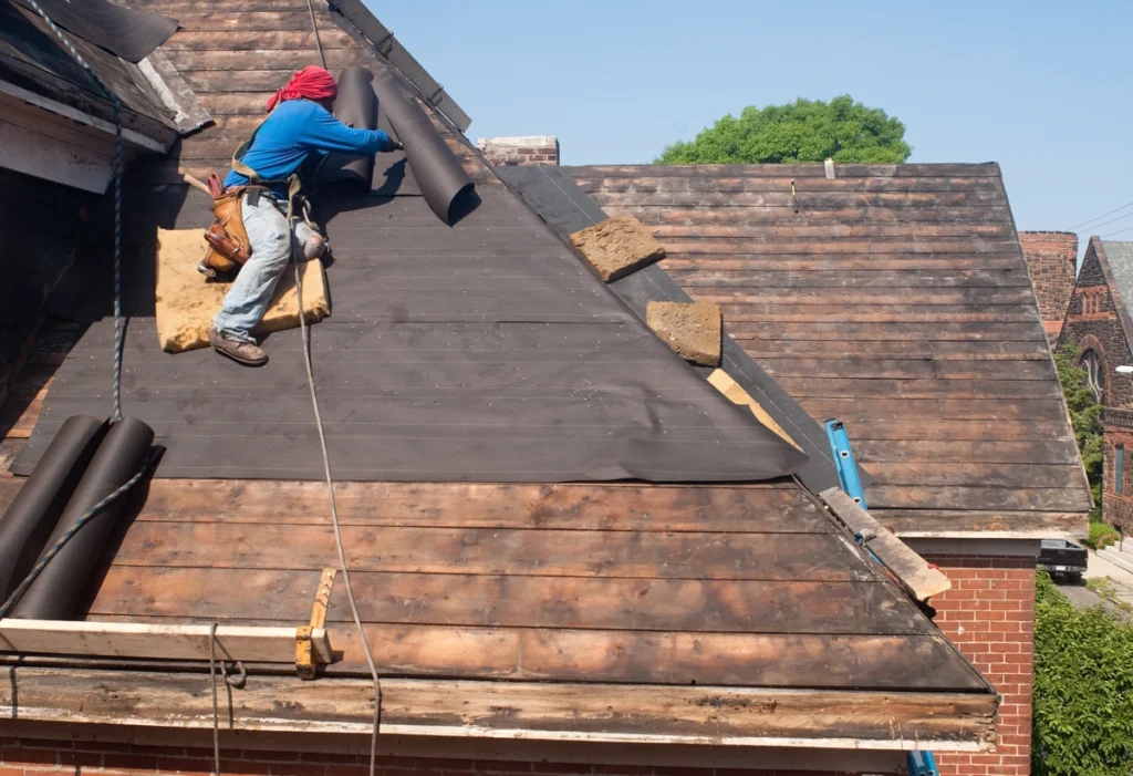 aged house roof repairing process by construction worker