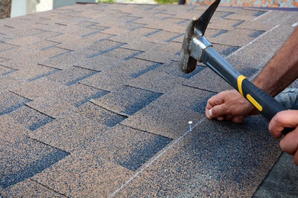 installing shingles with a hammer