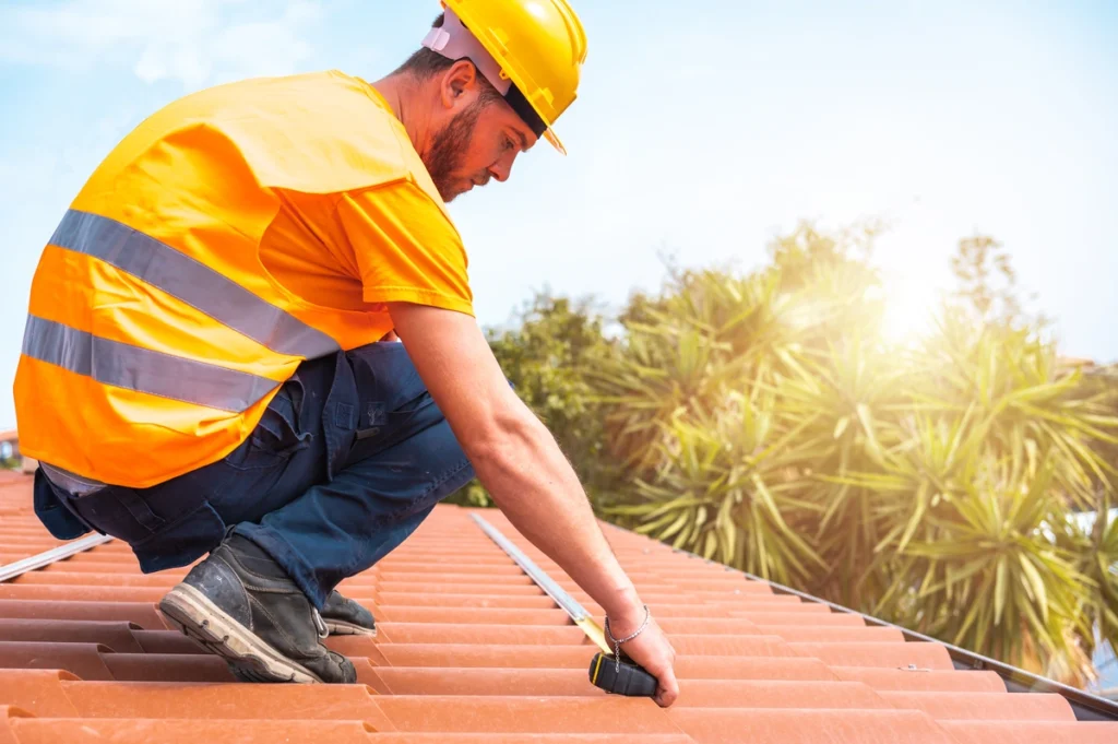 professional roofer measures a tile roof