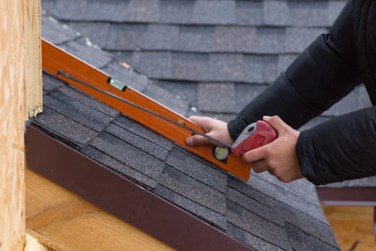 tape measure and level on a shingle roof